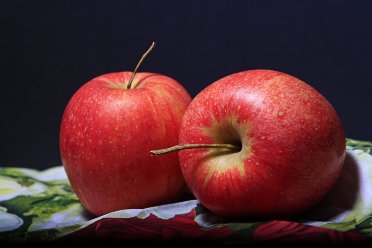 Two apples on top of a napkin