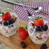 Yogurt parfait with plain yogurt, berries, granola and whole fruit.