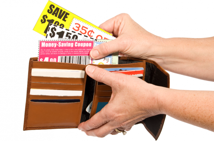 Woman holding wallet open to put coupons in.
