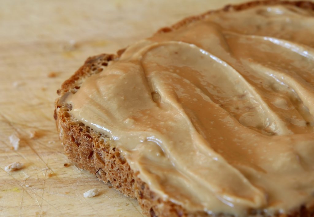 Bread with peanut butter spread on top.