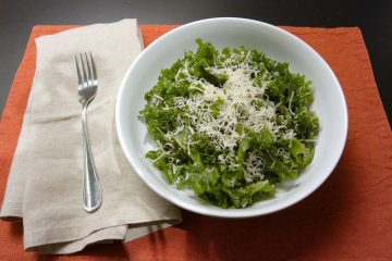 Massaged kale salad topped with shredded parmesan.