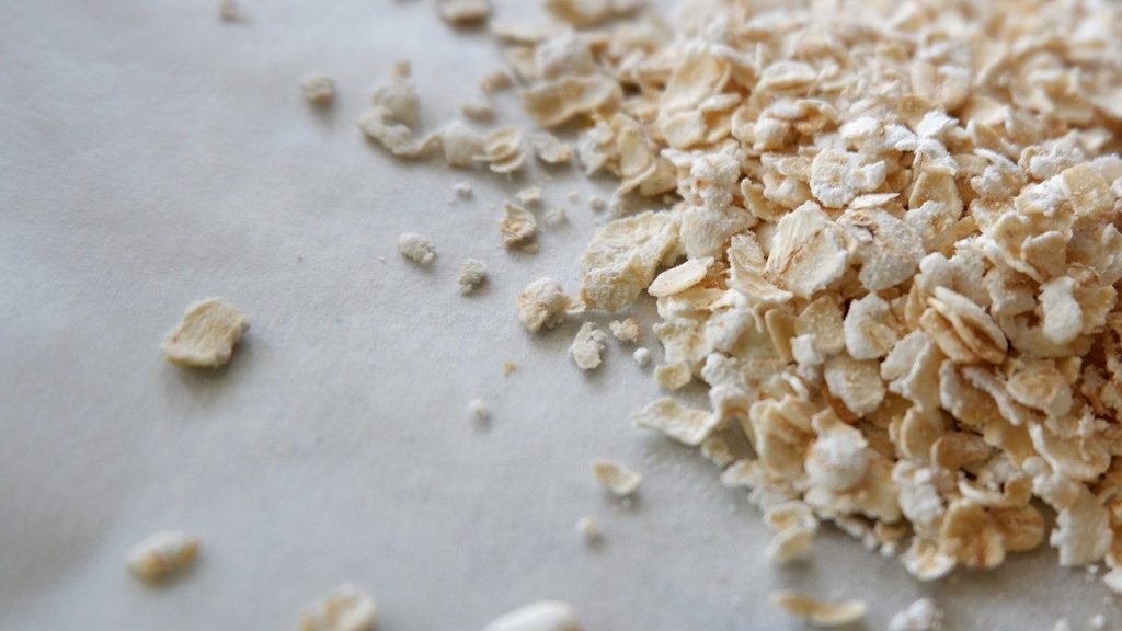 Uncooked oats on white surface.