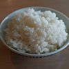 Cooked white rice in small bowl on table.